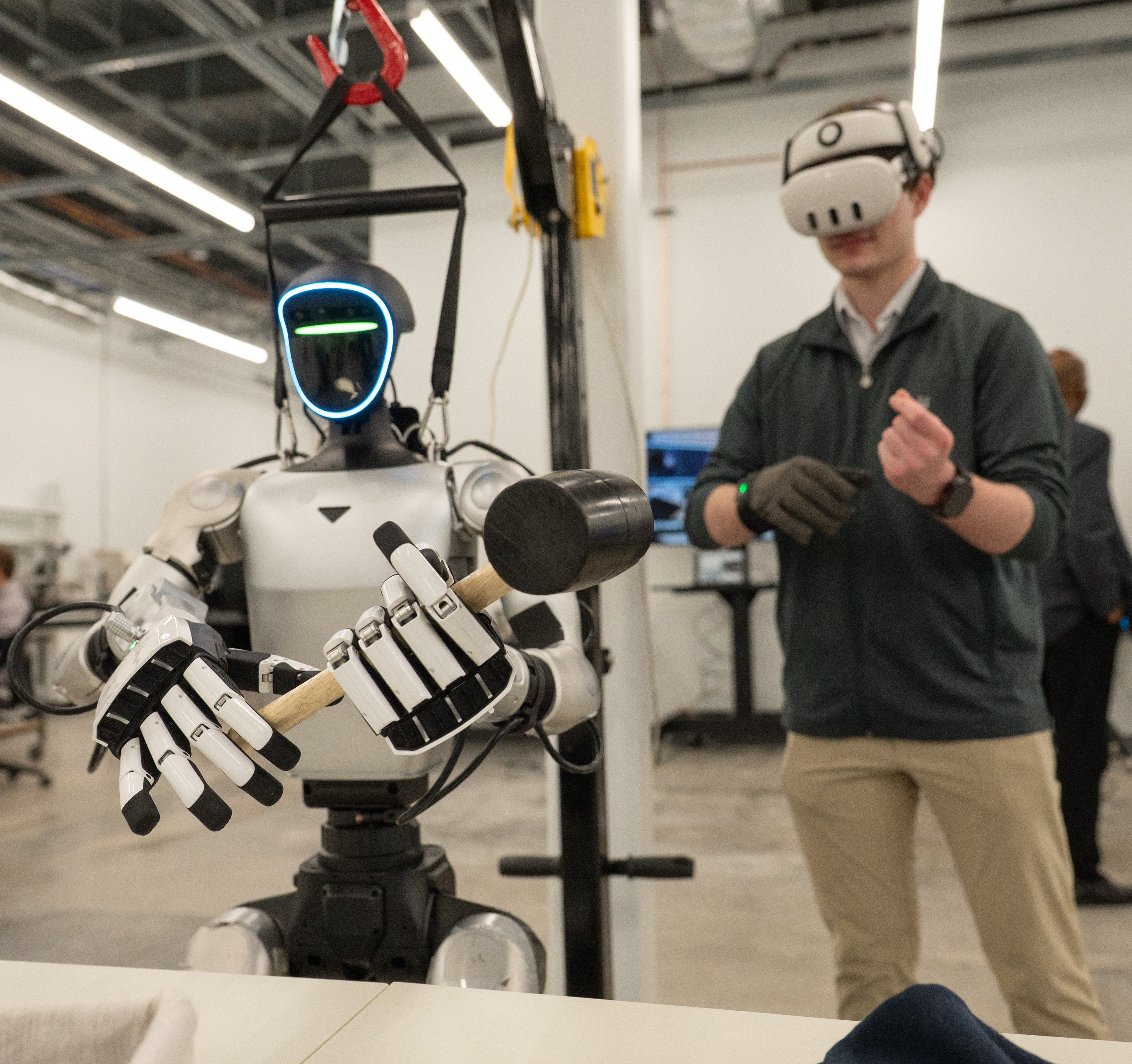 Robot and man with virtual reality goggles